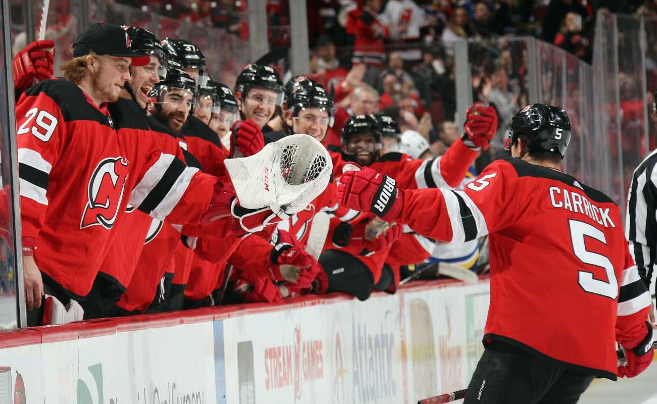 Connor Carrick #5 of the New Jersey Devils celebrates his goal with teammates