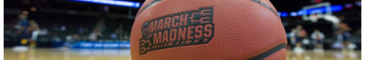 March College Basketball tournament ball sits on court; main focus, stadium background blurred