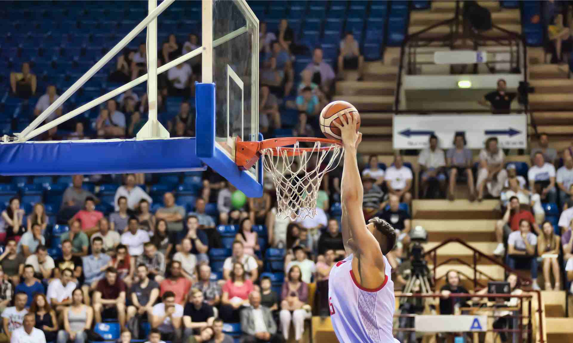 Player throws basketball into the basket