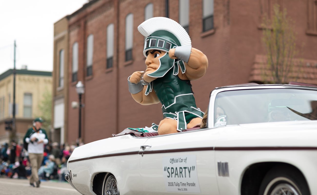 Sparty Michigan State Basketball mascot in car during parade