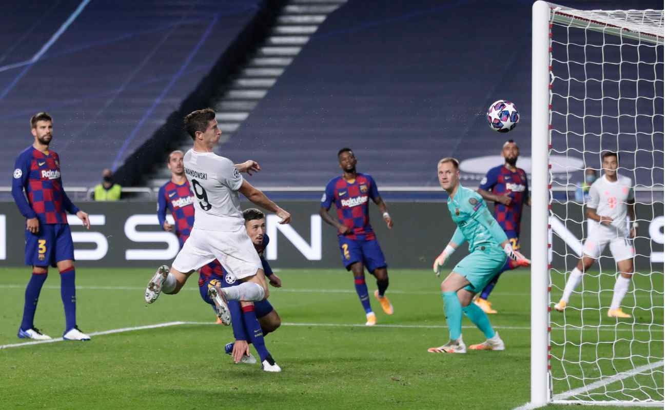 Robert Lewandowski heads the ball into the goal against Barcelona in the UEFA Champions League quarter-finals